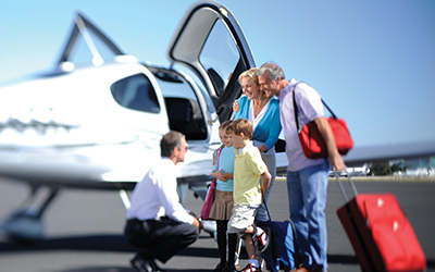 A family getting onto a private plane