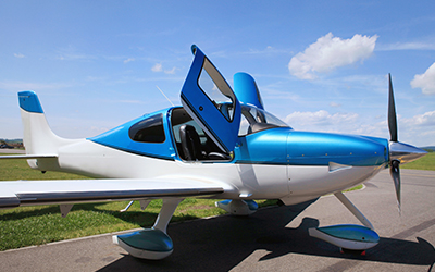 A cirrus aircraft sitting on the runway